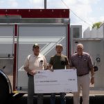 Viola Fire Chief Jim Davenport (left) and Mayor William Ramsey (right) are presented a grant check and the town's new 1,800 gallon pumper tanker (Photo: UCDD)