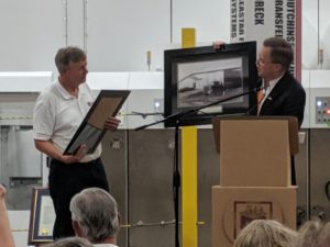 Putnam County Mayor Randy Porter (right) presents Cumberland Container Director Mark Jared (left) with a photo of the company's original building (Photo: Logan Weaver)